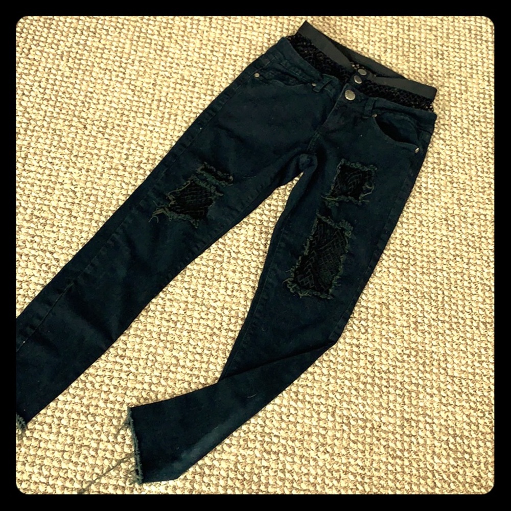 Black distressed fishnet V.I.P jeans.